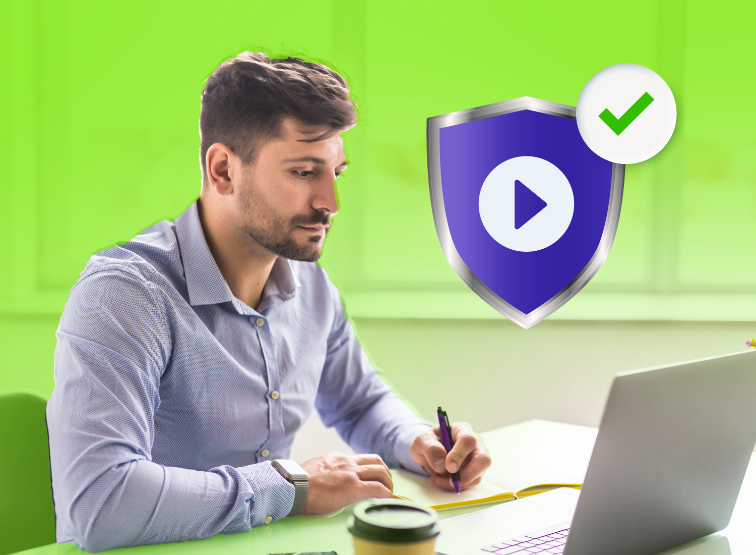 Man taking notes while watching something on his laptop, with a large shield icon containing a play button and a green checkmark overlaid, representing secure video training.